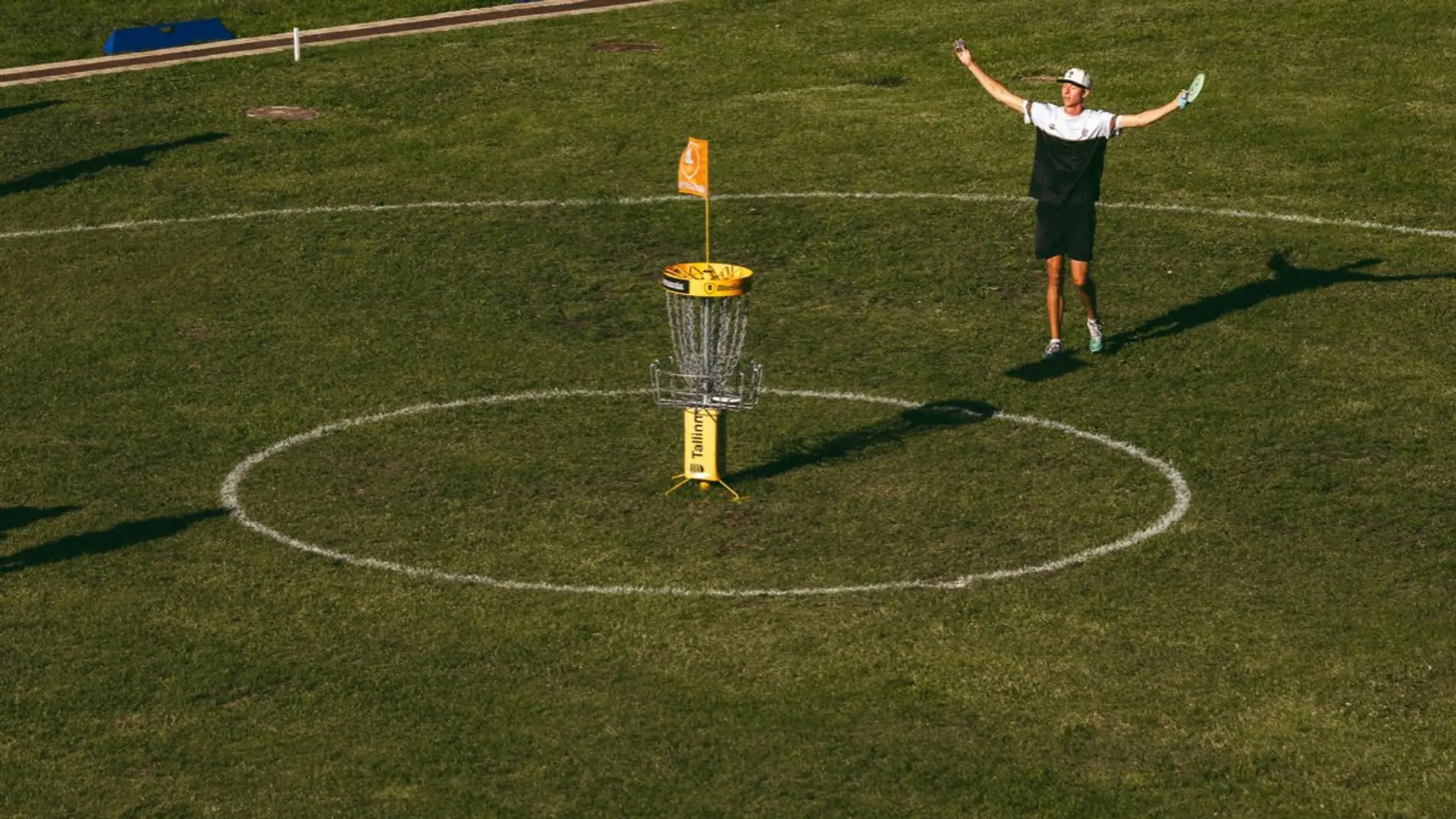 A player celebrating inside the putting circle, the gallery around him