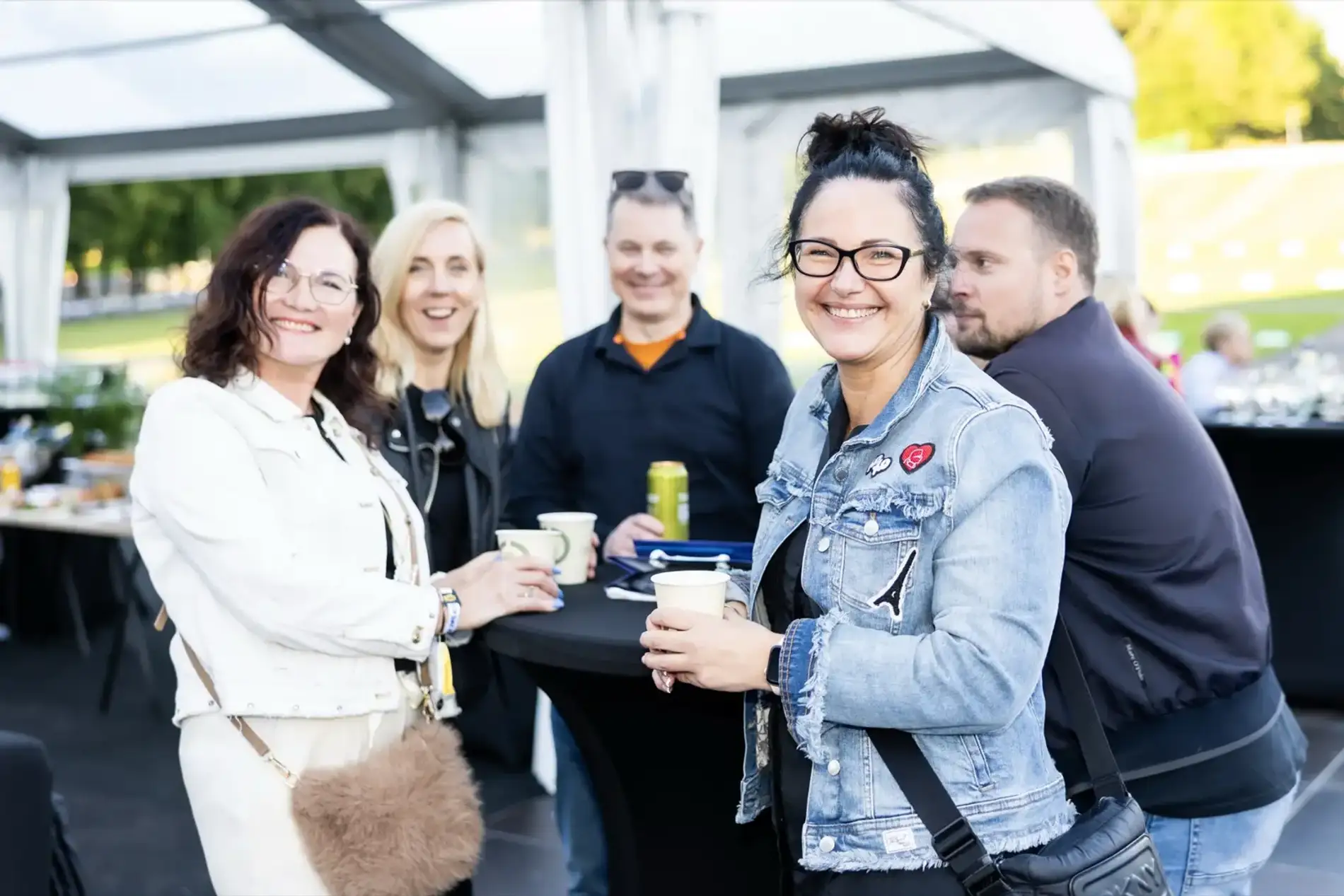 A hosted group with drinks in the VIP tent