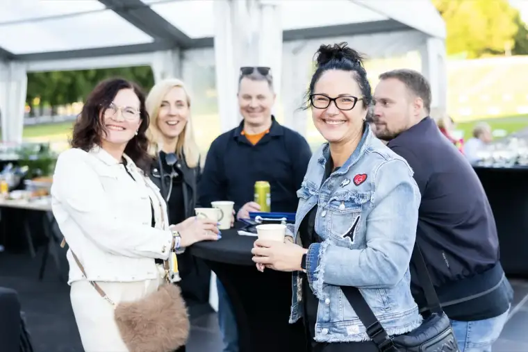 Guests with drinks in the VIP tent