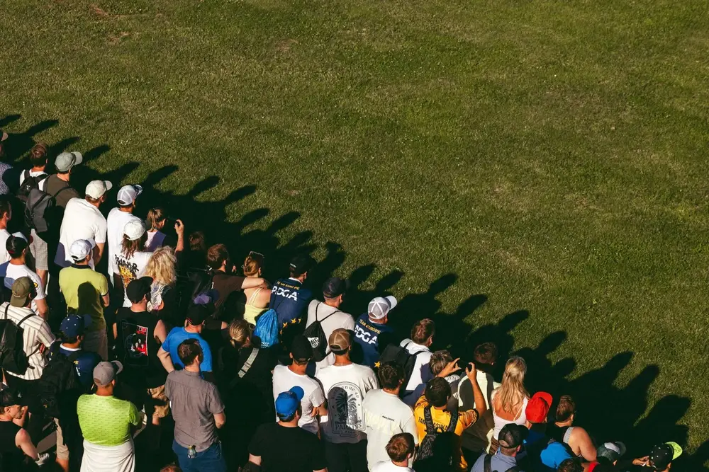 Spectators lining a fairway at the Song Festival Grounds, seen from above