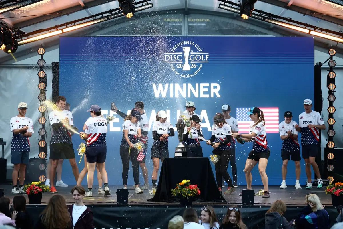 Team USA celebrating on the main stage, champagne in the air